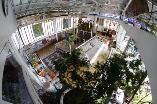 A spacious atrium with high ceilings, large windows, and a central seating area.