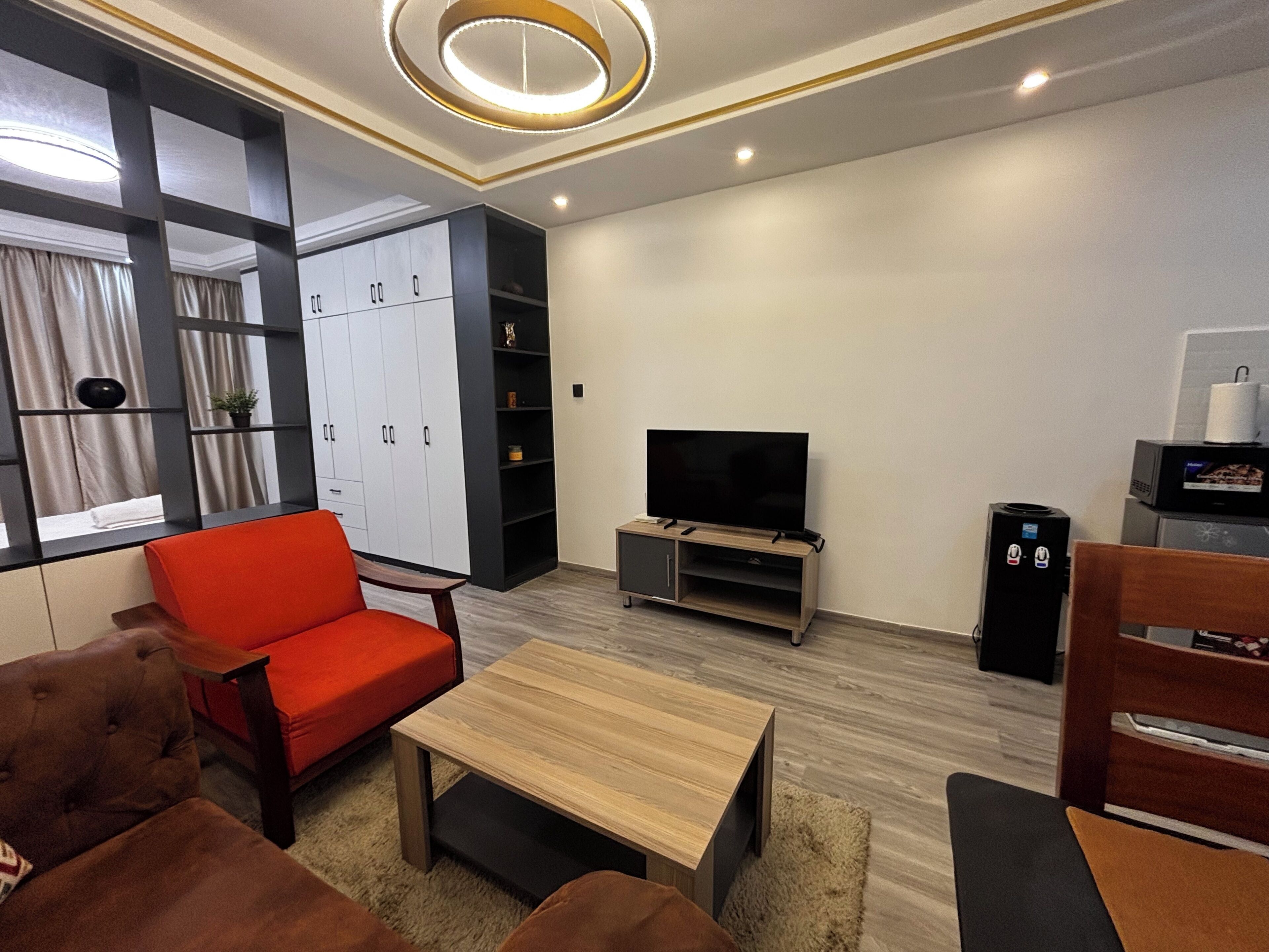 A modern living room with a sofa, a coffee table, a TV, and a cabinet.