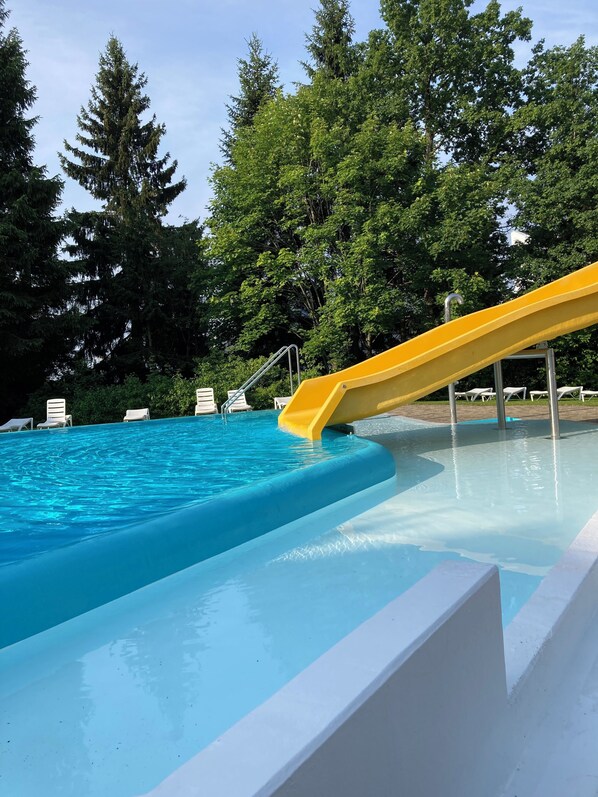 Relax by the pool surrounded by lush greenery and enjoy a refreshing swim or lounge on a comfortable chair.