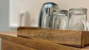 A wooden shelf with three glass jars and a kettle. -  SG Boutique Stay (Near Railway Station) (Udaipur)