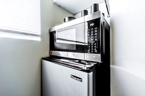 Efficient kitchen with a combination microwave and oven, featuring a digital control panel and sleek design.