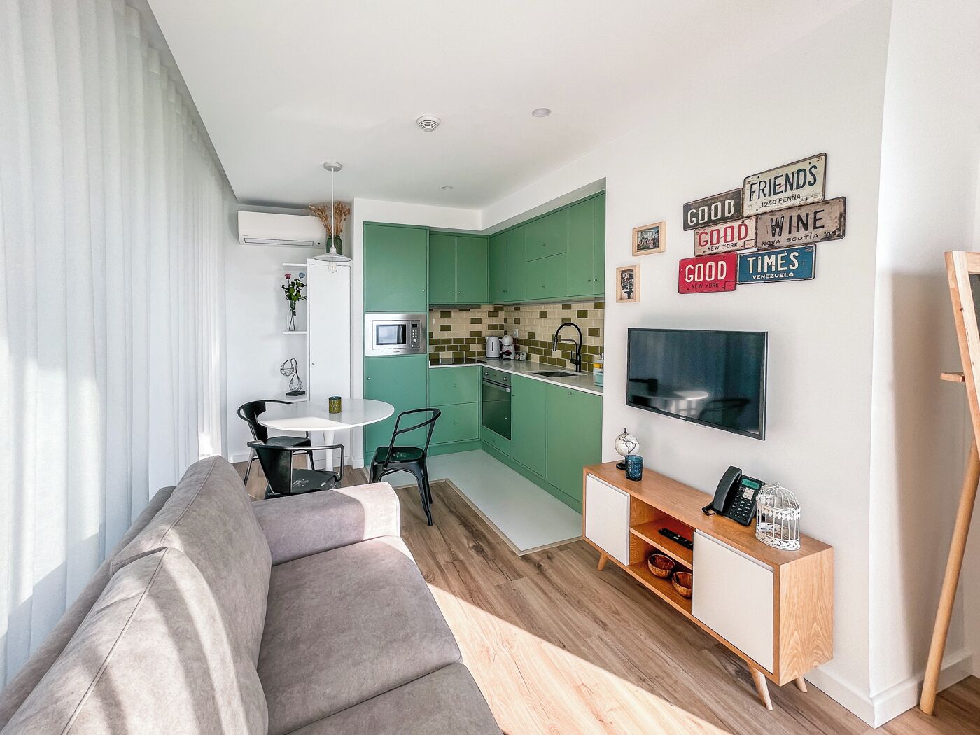 A modern apartment with a living room, kitchen, and dining area.