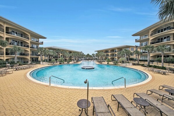A resort pool with lounge chairs and palm trees. - Adagio D-304 Poolside 3/3 with a Beautiful Pool View! (Santa Rosa Beach)