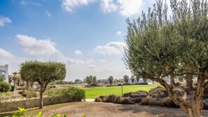 A golf course with a clear sky, a well-maintained lawn, and a few trees. - Casa Viv - Beautiful Spacious 2 bed apartment in the lovely La Torre Golf Resort (Torre-Pacheco)
