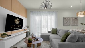 Una sala de estar moderna con un televisor de pantalla plana, un sofá, una mesa de centro y un comedor.