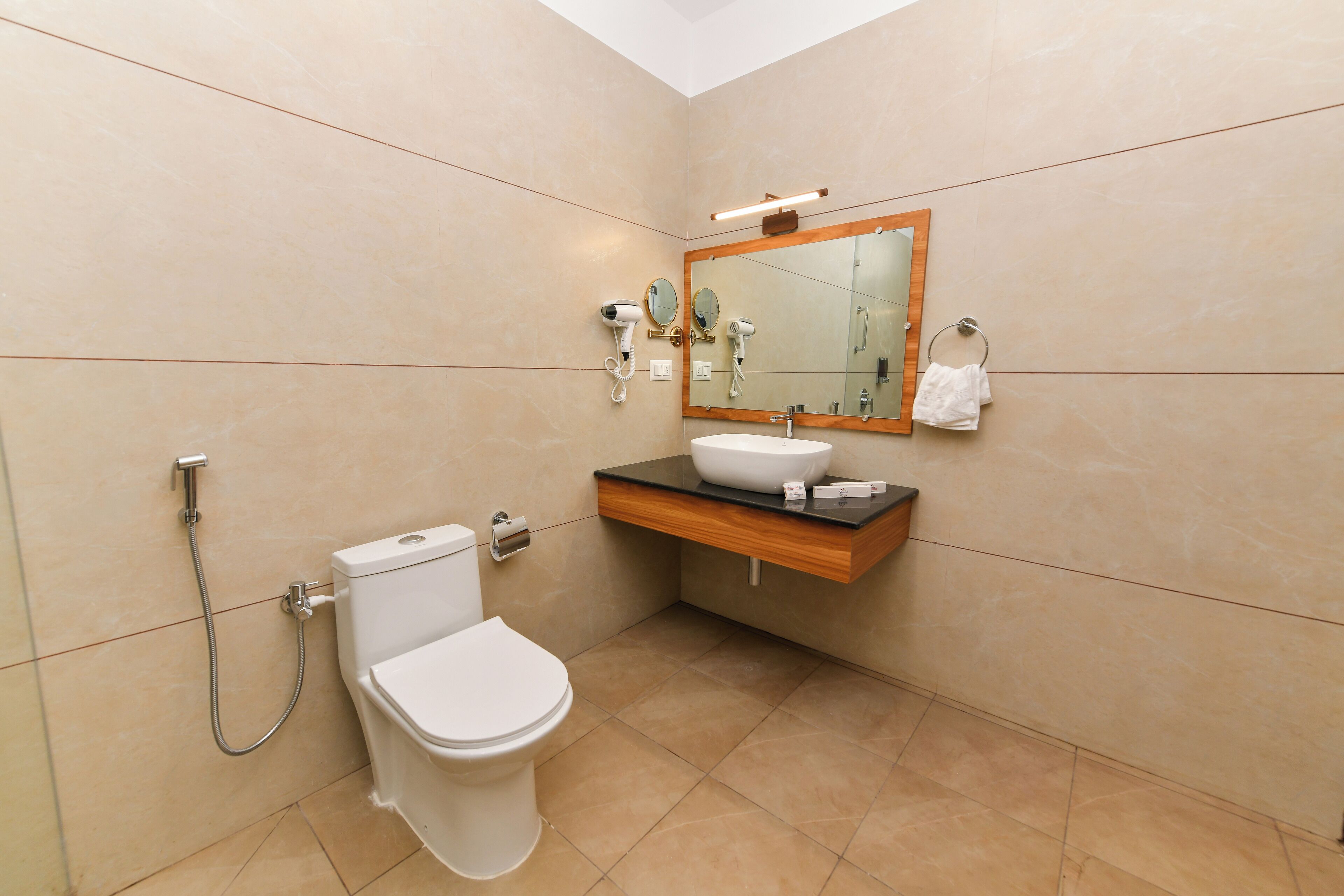 A bathroom with a toilet, sink, and shower.