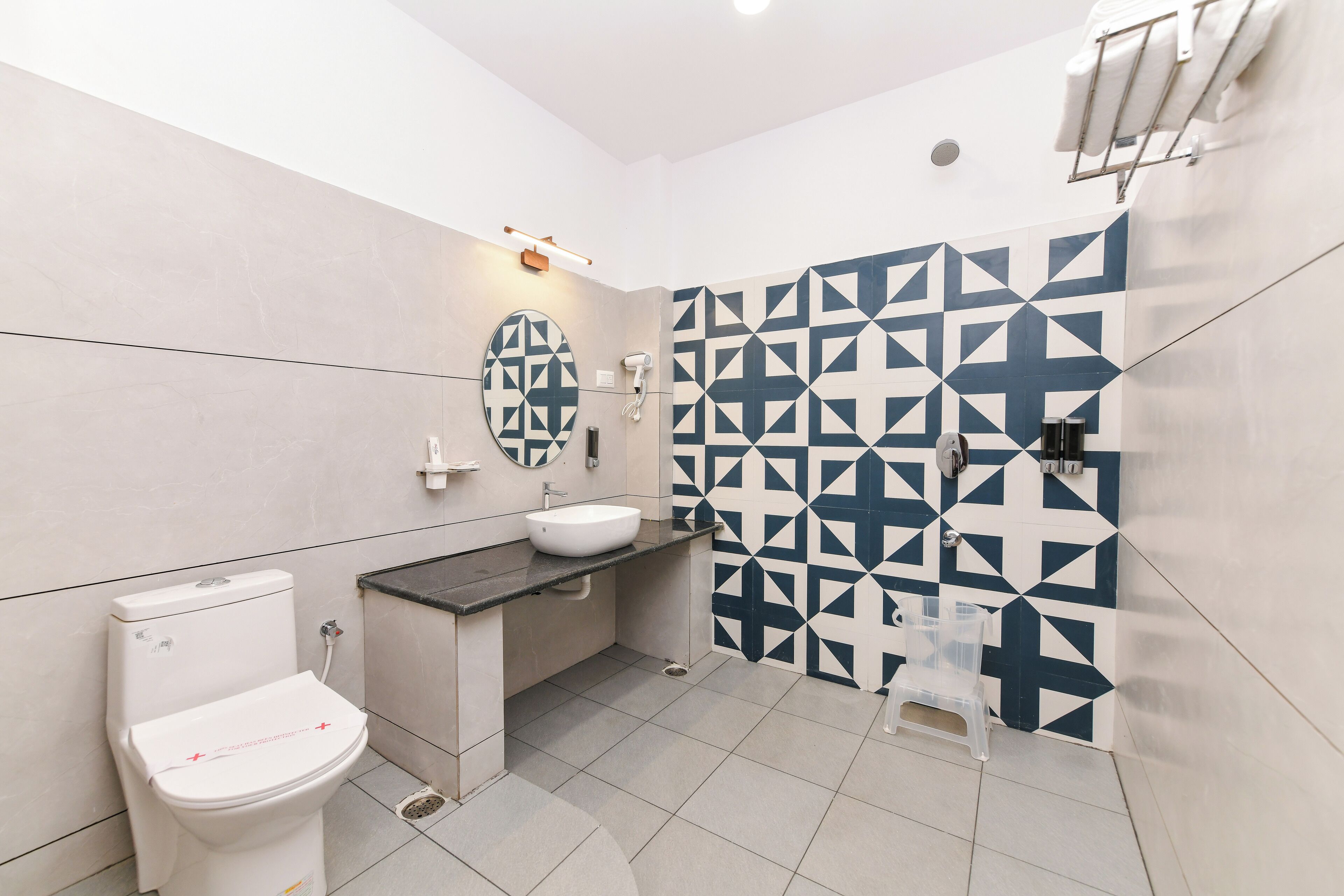 A modern bathroom with a toilet, sink, and shower.