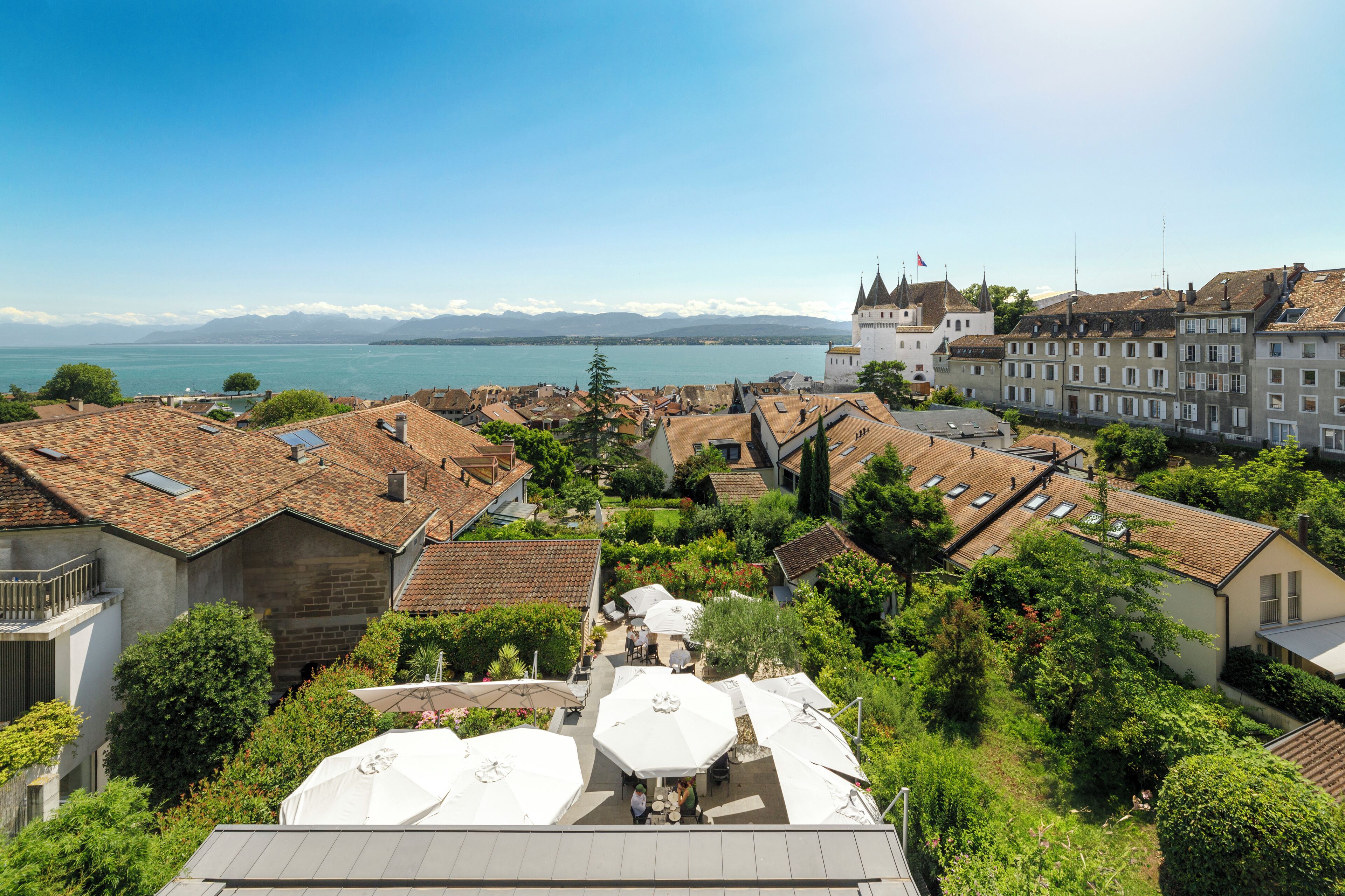 A residential area with a view of a lake and mountains.