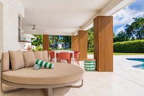 Kick back on the comfortable poolside daybed and enjoy a relaxing afternoon in the shade. - Resort Backyard with Sauna, Pool, Hot Tub & Sports (Plantation)