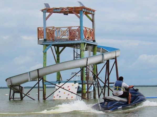 A water jet ski on a body of water with a metal structure in the background. - Daphne's Lagoon Lodge (Northern Lagoon)