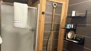 A bathroom with a shower, toilet, and sink. - Modern luxury- Rustic Charm (Afton)