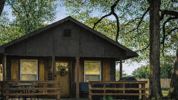A rustic wooden cabin with a porch, a table, and a bench. - Modern luxury- Rustic Charm (Afton)