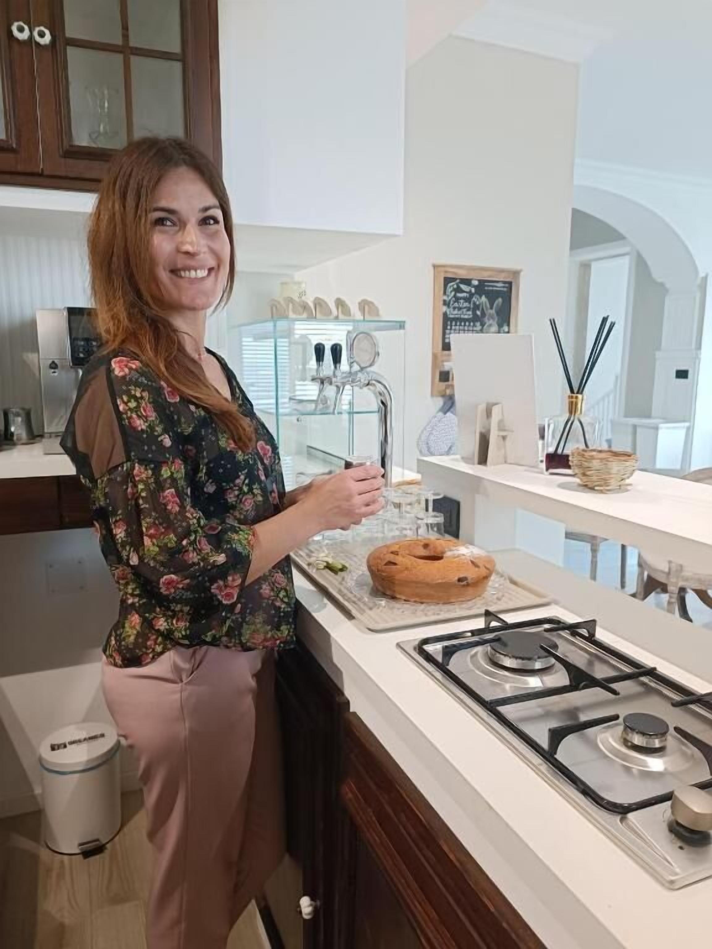 A kitchen with a gas stove, a sink, and a countertop with a loaf of bread.