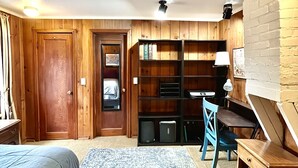 A bedroom with a bed, a desk, a chair, a bookshelf, and a door. - Keep it simple at this peaceful and centrally-located place.  (Polson)