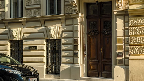A building with ornate architectural details, including statues and decorative moldings. - Roosevelt Stadthaus (Vienna)