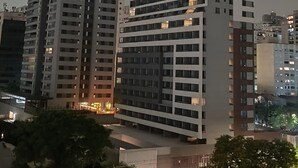 A high-rise building with multiple floors, large windows, and a modern architectural design. - Modern studio close to Allianz (Pompeia São Paulo)