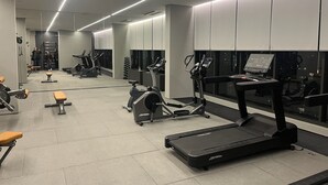 A modern gym with various exercise equipment, including treadmills and weight machines. - Modern studio close to Allianz (Pompeia São Paulo)