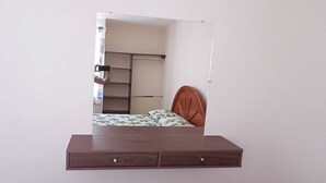 A bedroom with a bed, a wooden dresser, and a wardrobe. - Princesa Department. Huatulco. (Santa Cruz Huatulco.)