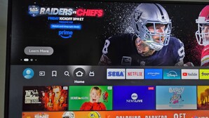 A television screen displaying a sports event between the Raiders and Chiefs, with a Prime Video logo and a "Learn More" button.