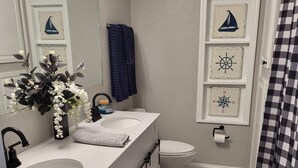 A bathroom with a white vanity, two sinks, a toilet, and a shower curtain. - Snow Bird Alert -3 Month Rental - Venice Isle Estates -2 Bed 2 Bath House  (Venice)