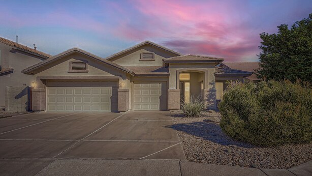 A residential house with a garage, driveway, and landscaping. - Cactus Bloom - Cozy Desert Retreat in Chandler (Chandler)