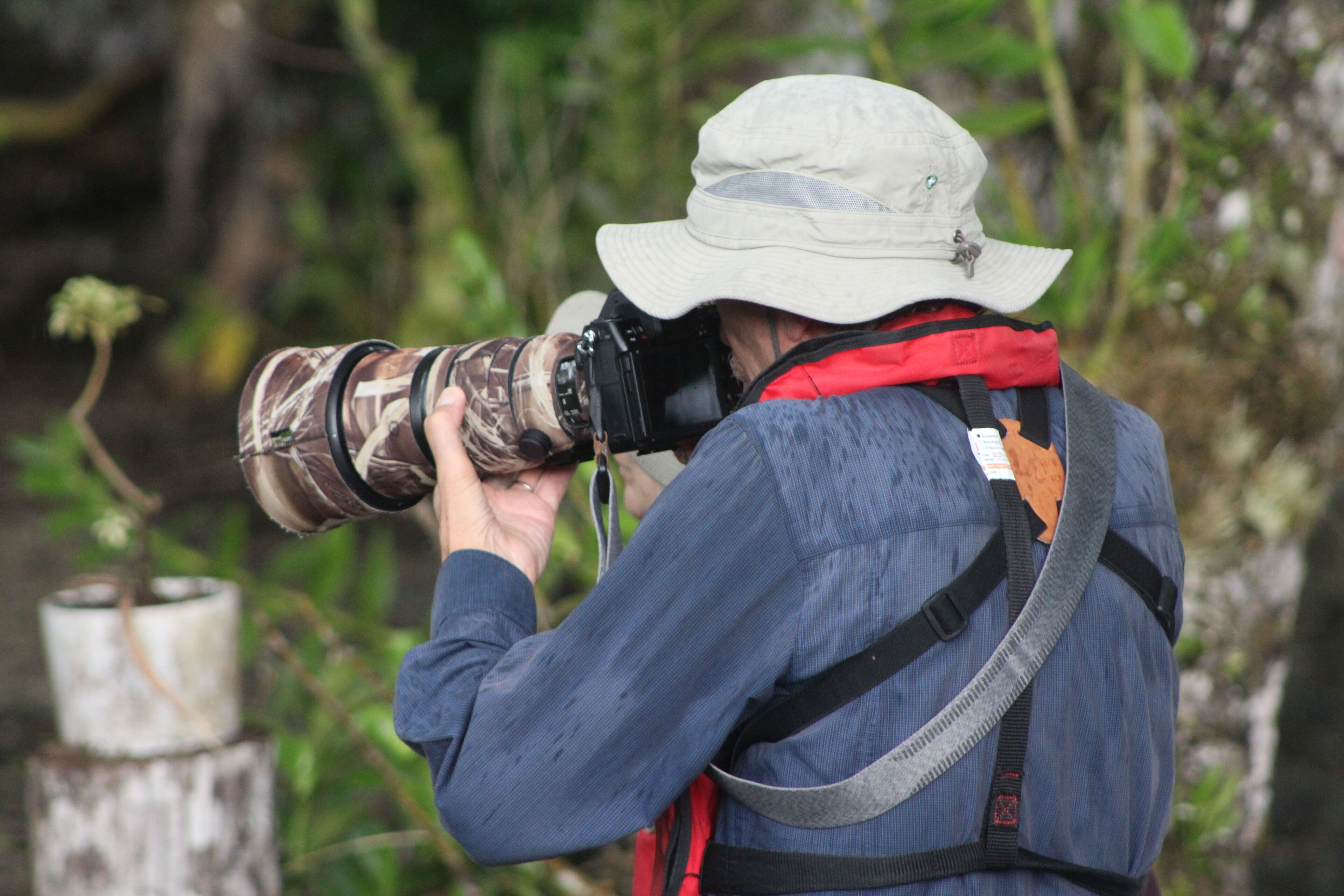 A person taking a photograph with a large camera.