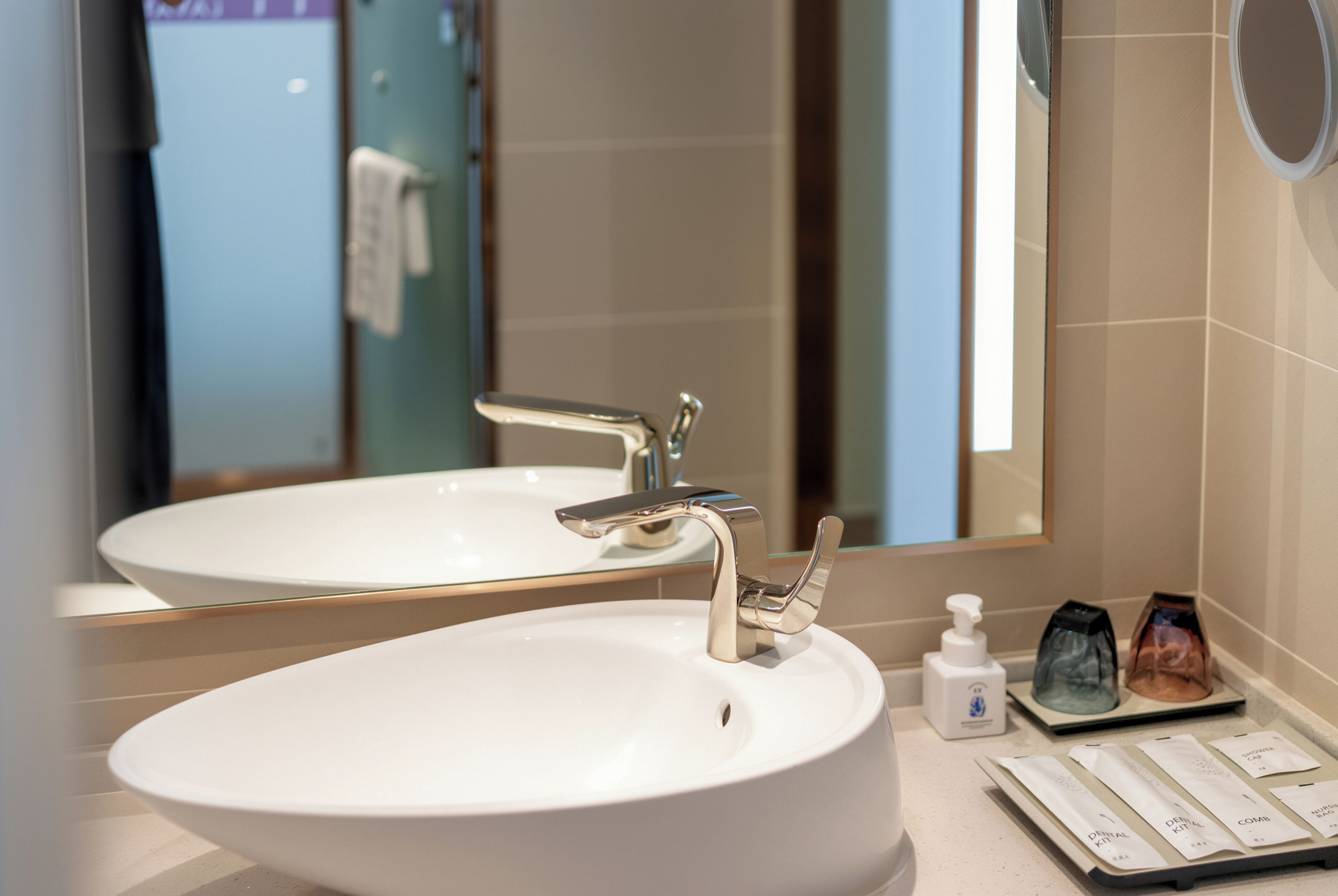 Une salle de bain avec un lavabo blanc, un miroir et un porte-serviettes.