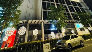 A high-rise building with a modern architectural design, featuring large windows and a prominent entrance. - Agile Premium Service Suite KL (Kuala Lumpur)