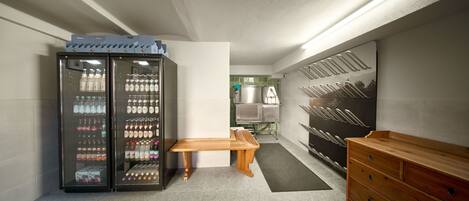A modern kitchen with a built-in refrigerator, a wooden bench, and a wooden dresser.