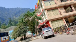 A multi-story building with a sign for 'Sapphoro Chana Kya Resort'. - Sapphero Chanakya Resort  (Narendranagar)