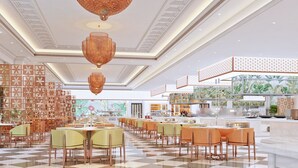 A spacious hotel lobby with checkered flooring, multiple dining areas, and a large window with a tropical mural. - OZEN MANSION KOLKATA (Barasat)