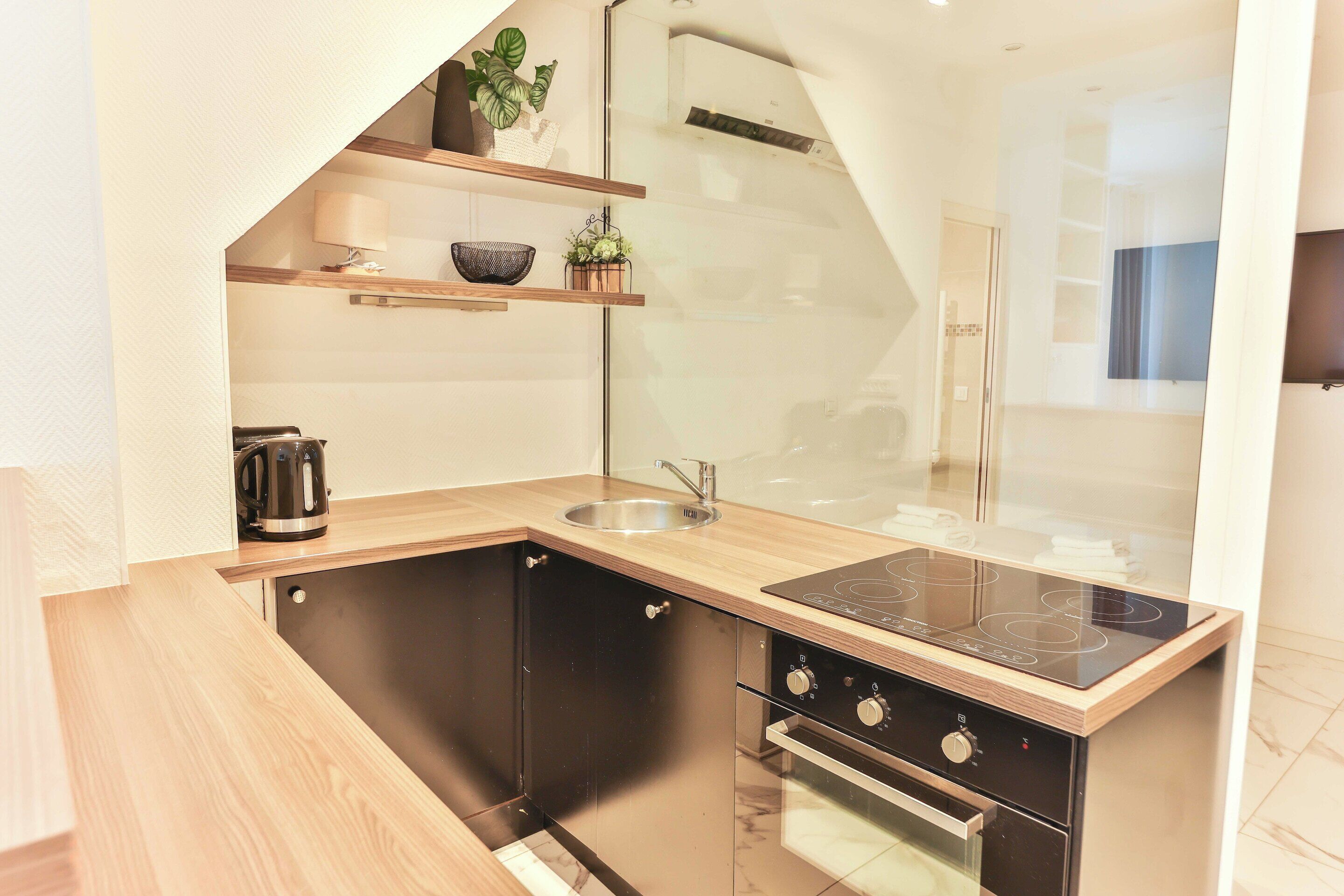 A modern kitchen with a built-in stove, oven, and dishwasher.