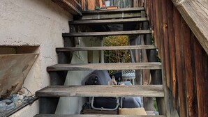 A narrow wooden staircase leading to a higher level, with construction materials and tools visible on the steps. - 2-bedroom apartment, 5 guests, village center with parking (Arêches-Beaufort)