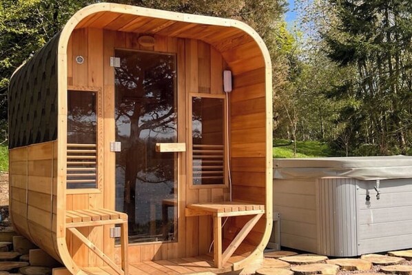 A wooden sauna with a curved roof, a glass door, and a small bench outside. - Little Gem at Lough Sillan House | Romantic, Adults only with hot tub and sauna (Shercock)