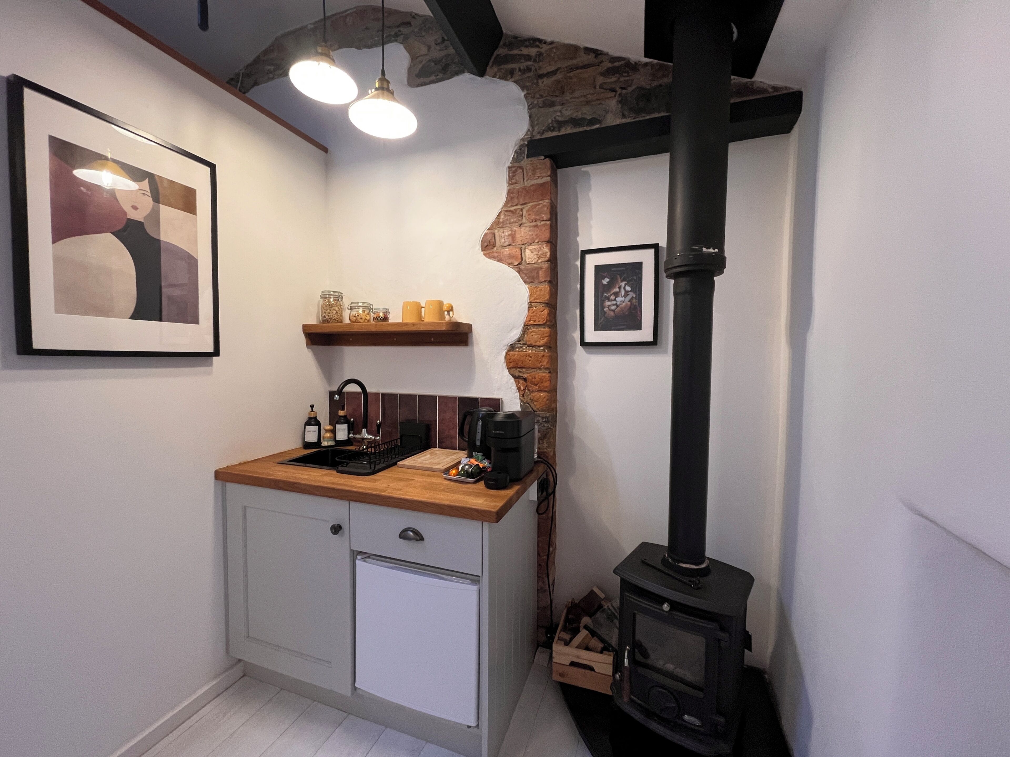 A kitchen with a built-in stove, a sink, and a countertop with a coffee maker.