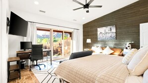 A bedroom with a bed, a desk, a chair, a TV, and a ceiling fan. - Thunder Mtn, Coffee Pot Views, Hot Tub Getaway (Sedona)