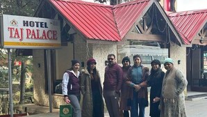 A group of people standing in front of a building with a sign that reads "HOTEL TAJ PALACE". - Hotel Taj palace Dalhousie (Dalhousie)