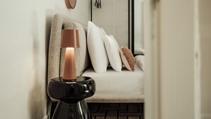 A modern interior with a sofa, cushions, and a decorative candle holder. - Ellul Living (Floriana)