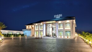 A modern hotel with a large entrance, well-lit facade, and a clear sky. - Enrise by Sayaji Dwarka (Dwarka)