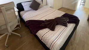 Une chambre à coucher avec un lit, un bureau et une armoire.