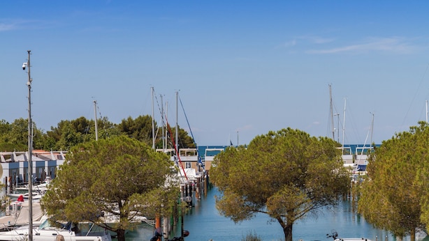 A marina with boats docked, surrounded by trees and buildings. - Premium Levant 212 Marina Apartment (Piran)
