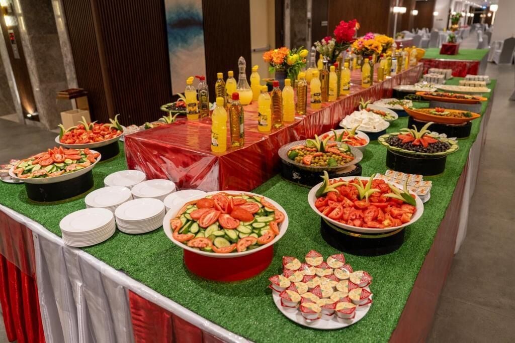 A buffet table with various food items and condiments.