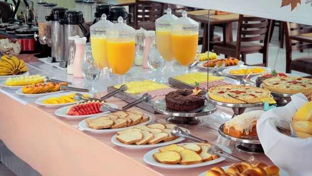 A buffet with various food items and beverages.