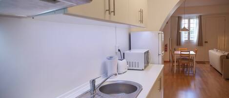 Fridge, microwave, coffee/tea maker, cookware/dishes/utensils