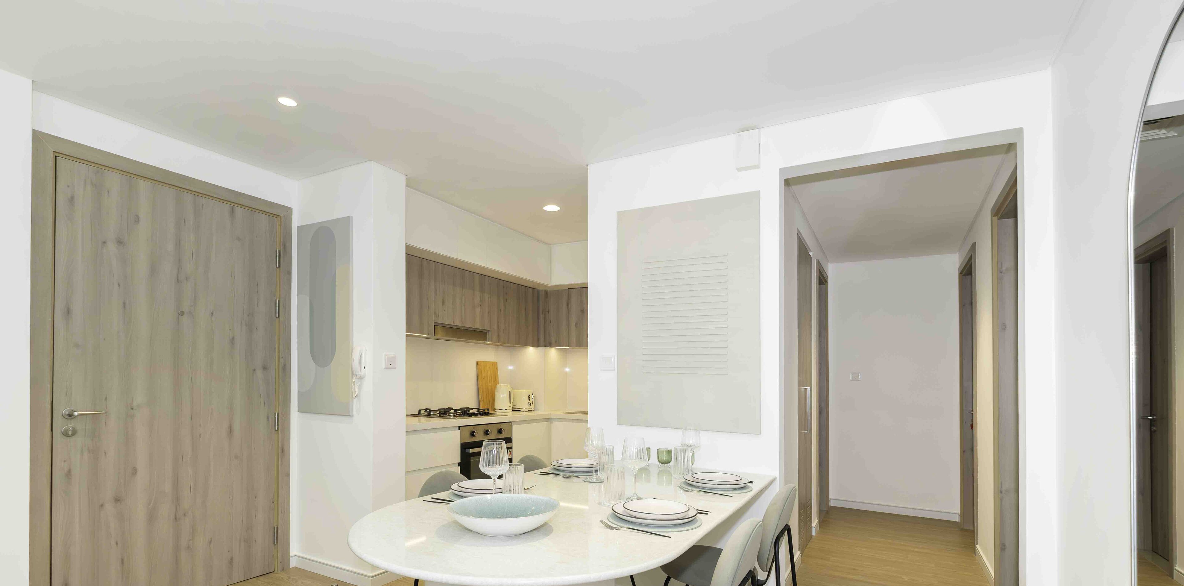A modern kitchen with a dining area.