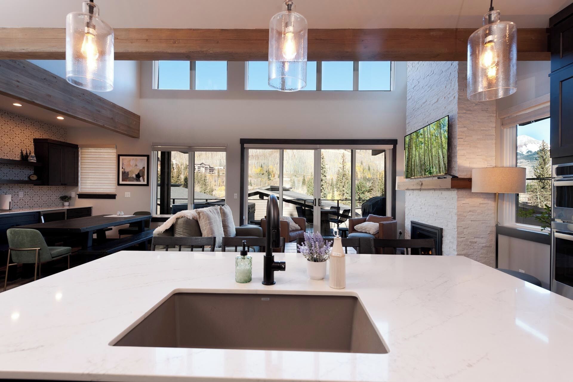 A spacious kitchen with a large island, modern appliances, and a view of the outdoors.
