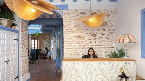 Un área de recepción con pared de ladrillo, un mostrador de madera y una botella de champán.