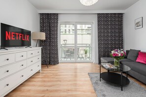 Comfort Apartment | Living area | 40-inch plasma TV with cable channels