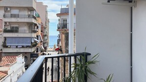 A narrow street between buildings with balconies overlooking a body of water. - Budha's apartment, relax & confort center Calafell (Calafell)