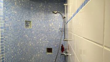A bathroom with a bathtub, a shower, and a sink.